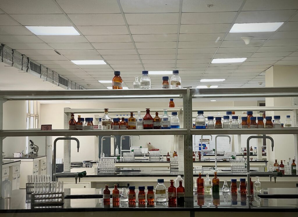 pexels photo 11703173 11703173 A detailed view of a modern science lab with chemical bottles and test tubes.
