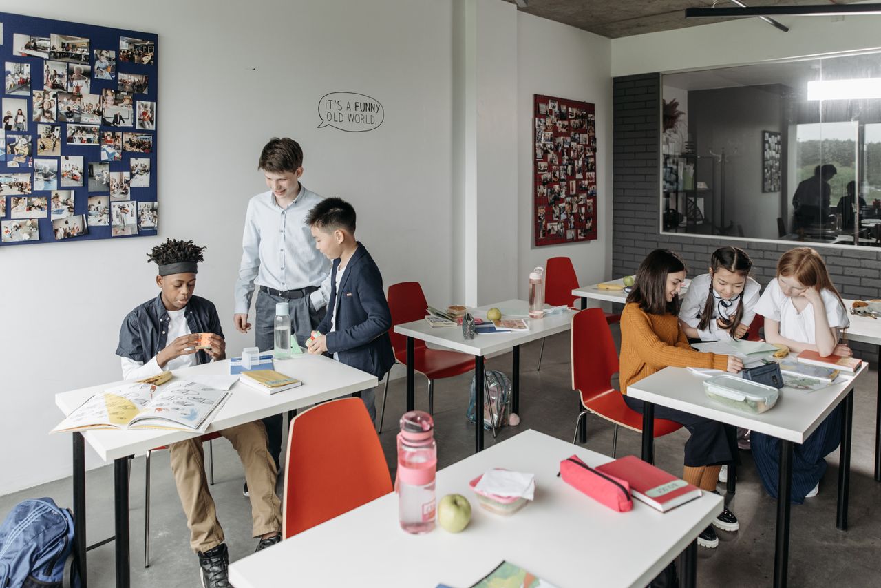 Mastering the First Impression: Your intriguing post title goes here A diverse group of students engaged in a classroom setting, collaborating and studying.
